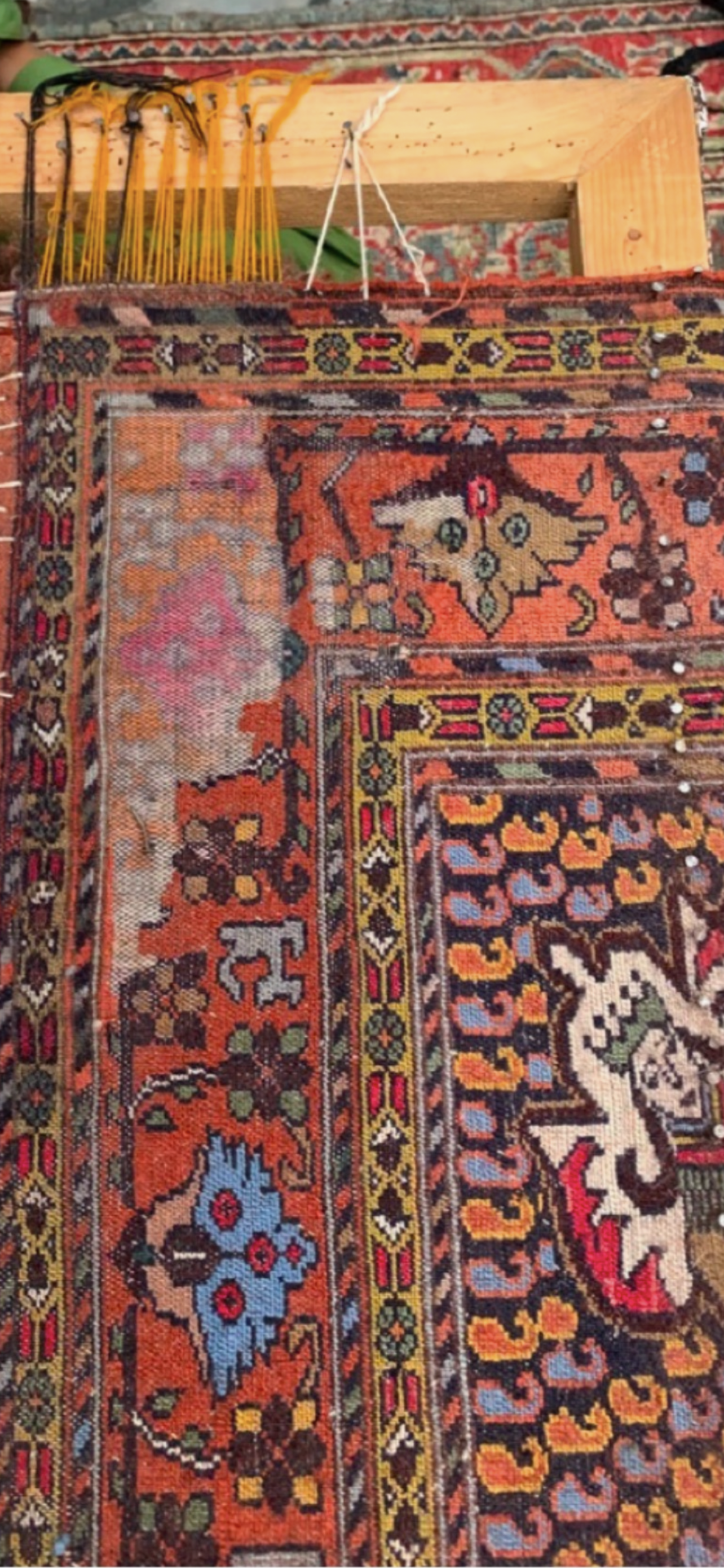 A colorful rug is sitting on top of a wooden table.