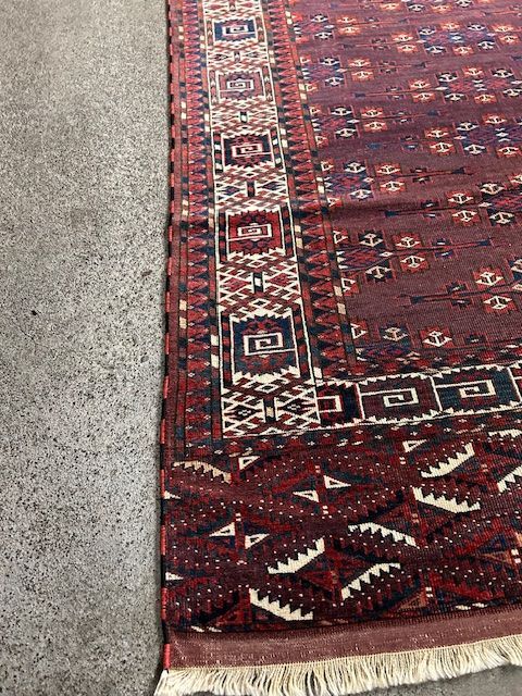 A rug with a pattern on it is sitting on the ground