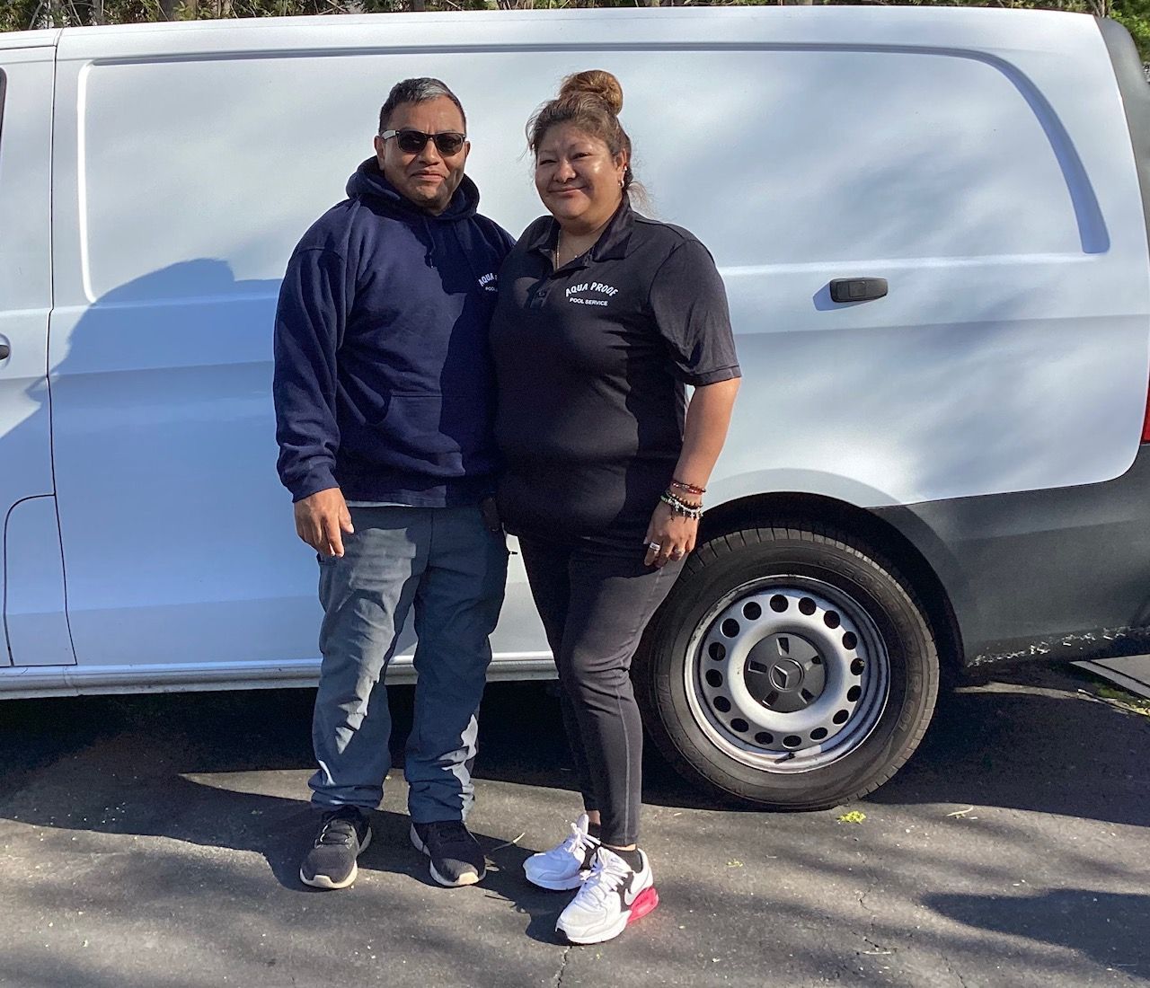 Aqua Proof founders pose by a white van