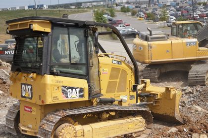 A Volvo excavator is digging a hole in the dirt