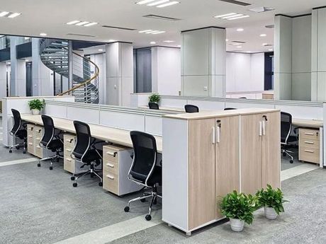 A large office with a lot of desks and chairs.