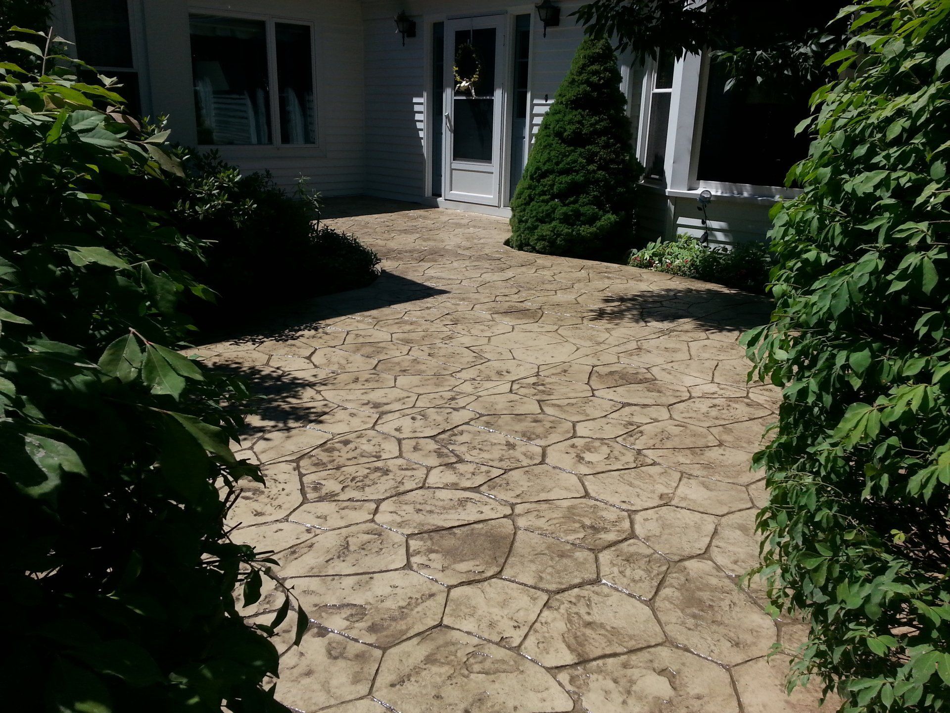 a stone walkway leading to the front door of a house
