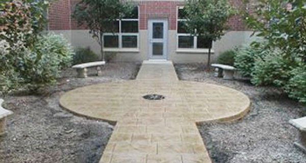 a patio with a fire pit and a table and chairs
