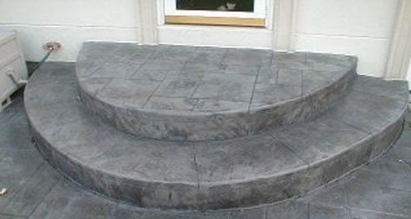 a set of concrete steps leading up to a house .