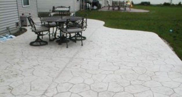 a patio with a table and chairs on it