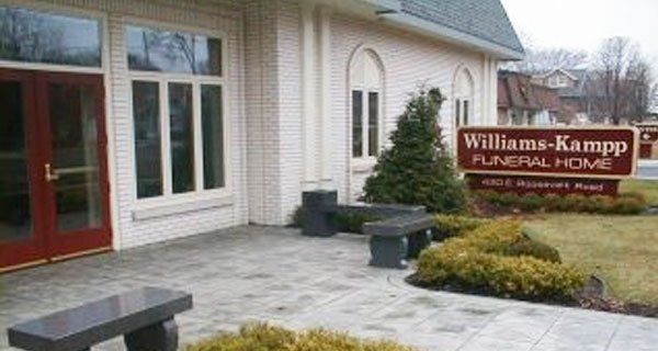 a white building with a sign that says williams kampp funeral home