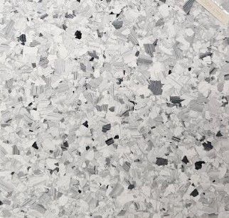 A close up of a gray and white granite counter top.