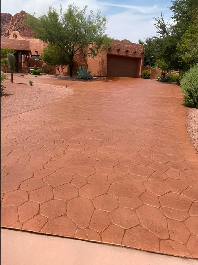 A brick driveway leading to a house with a garage.