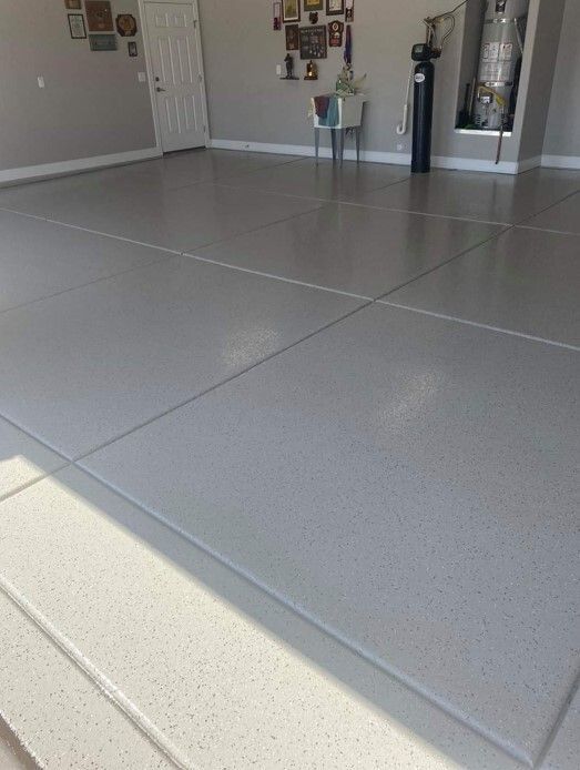 A garage with a concrete floor and a water heater.