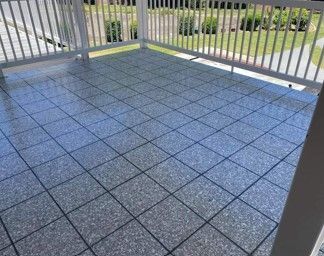 A balcony with a tiled floor and a white railing.