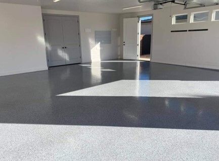 A garage with a black and white floor and white walls.