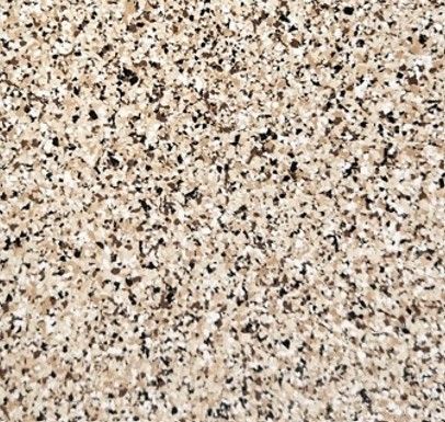A close up of a concrete floor with a lot of small stones on it.