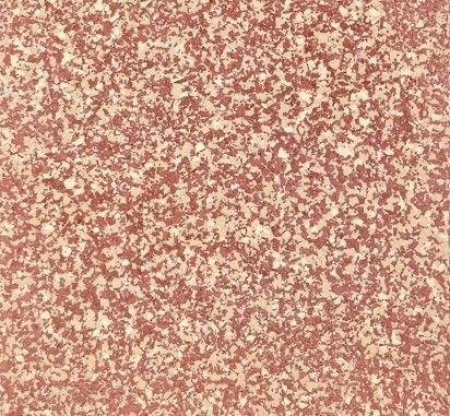 A close up of a red and gold tile floor with a shiny finish.