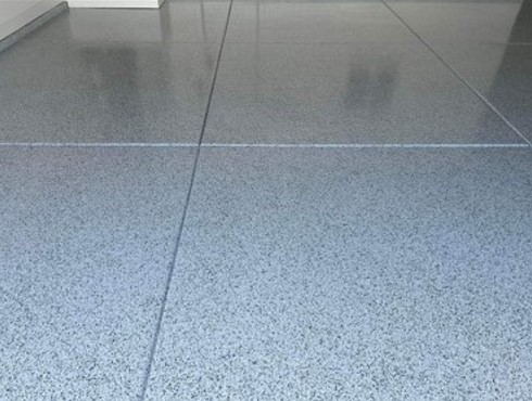 A close up of a gray epoxy floor in a room.