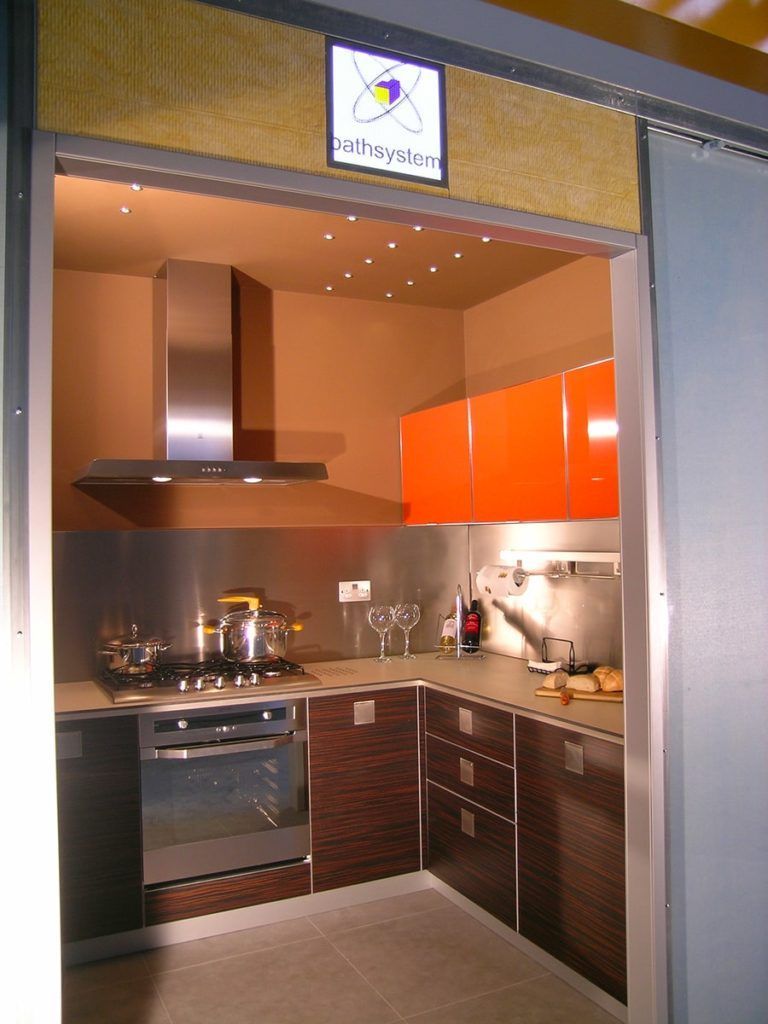 Modern kitchen with orange cabinets, stainless steel appliances, and brown cabinetry.