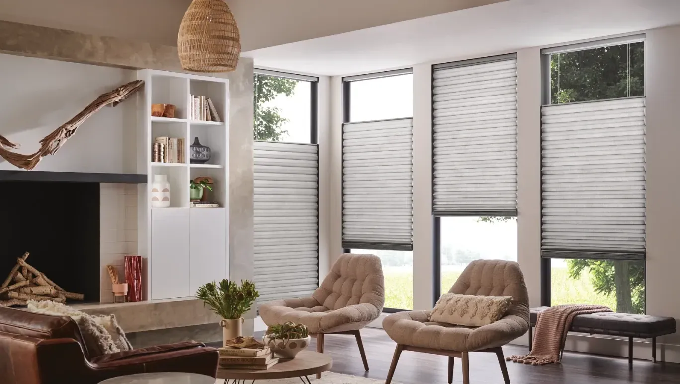 a living room with a couch, chairs, a table and a fireplace