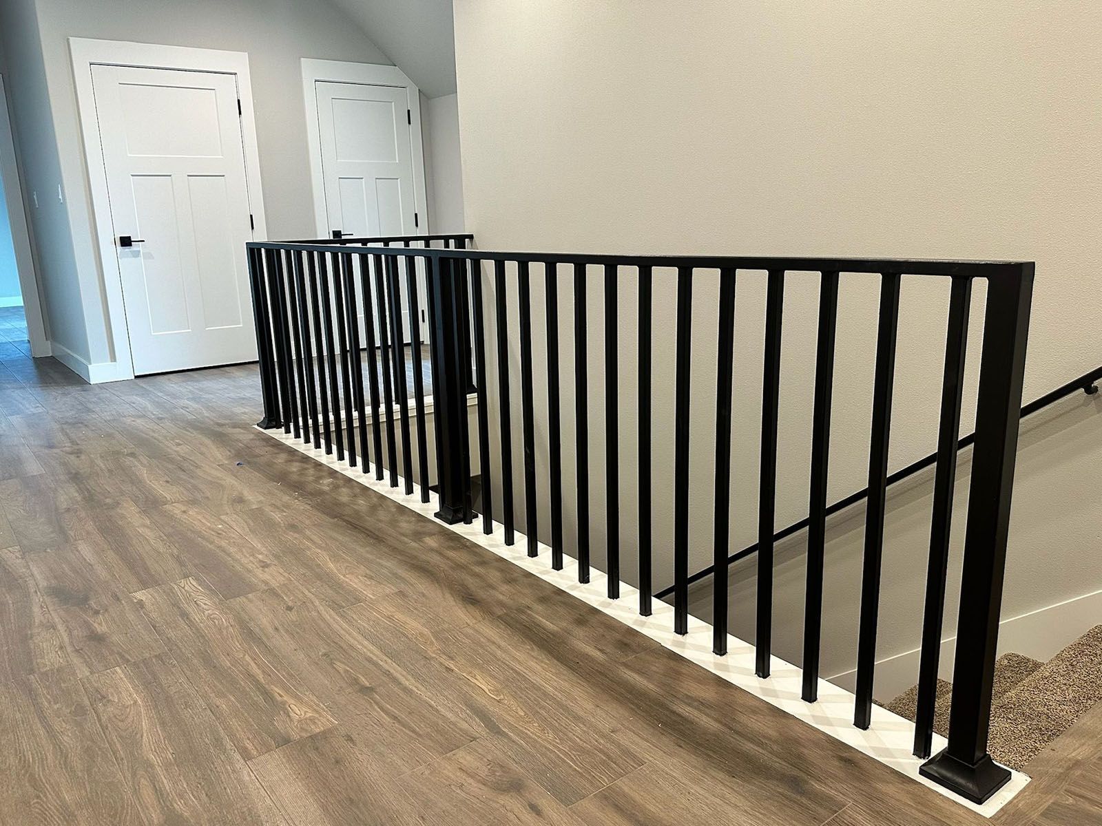 Black metal railing along a staircase landing
