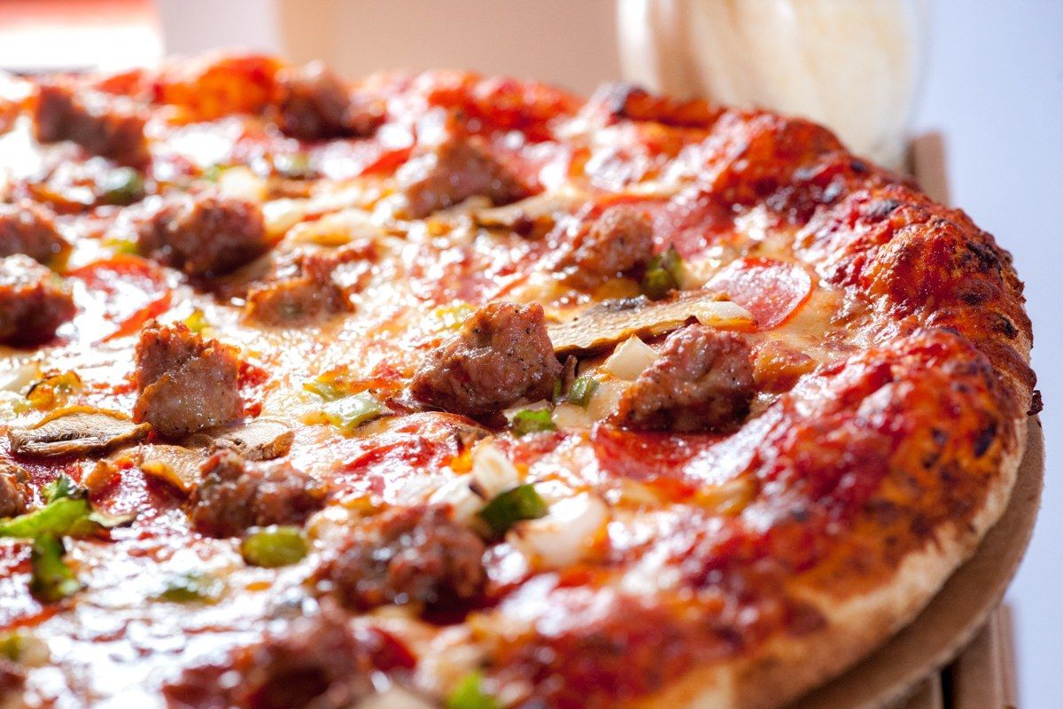 Pizza topped with sausage, peppers, and mushrooms.