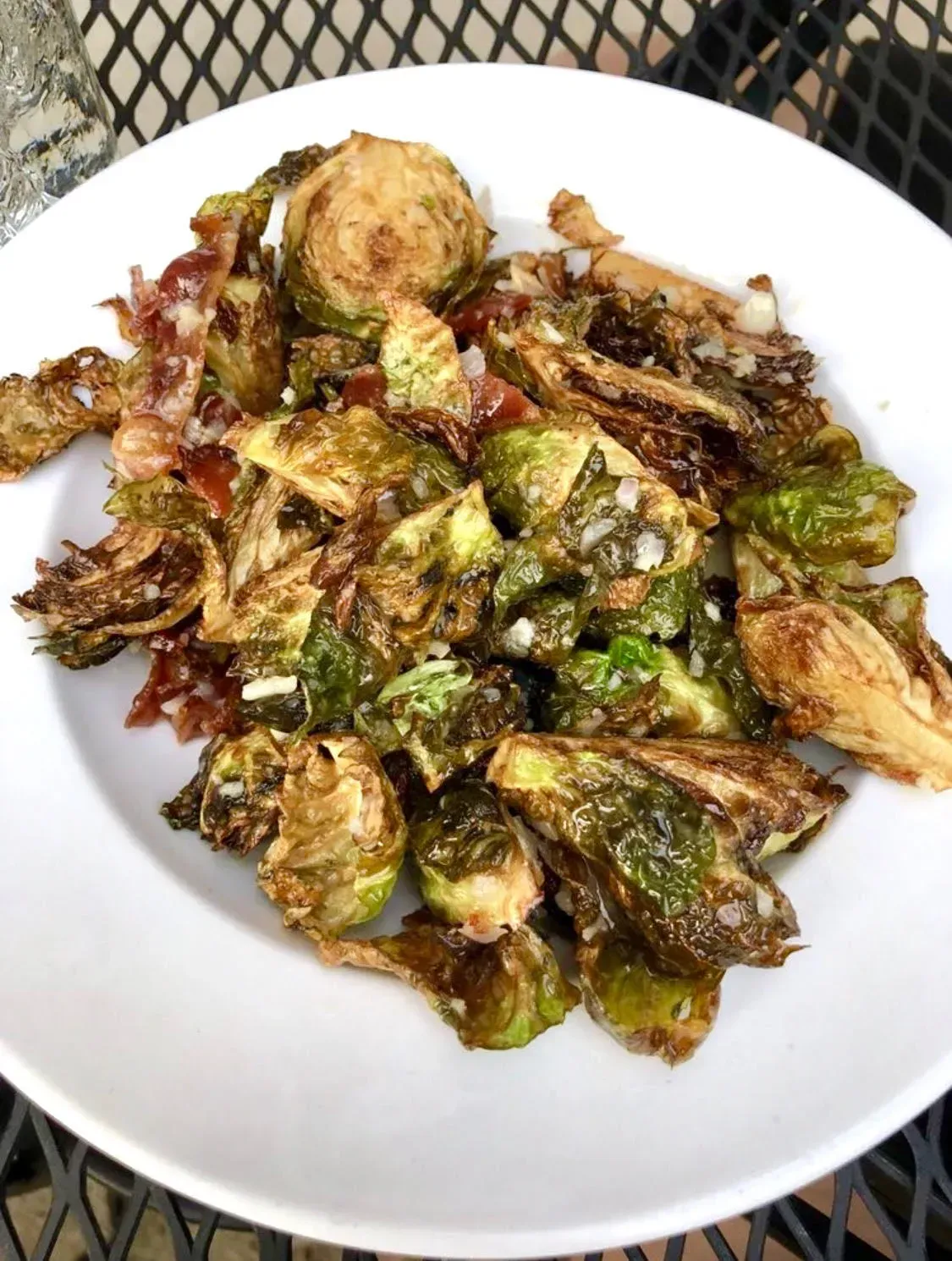 Plate of sautéed Brussels sprouts and browned vegetables on a white dish