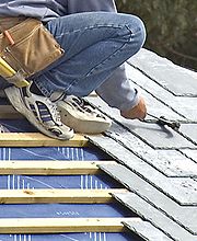 Roofer installing tile