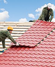 Roofers installing metal roof