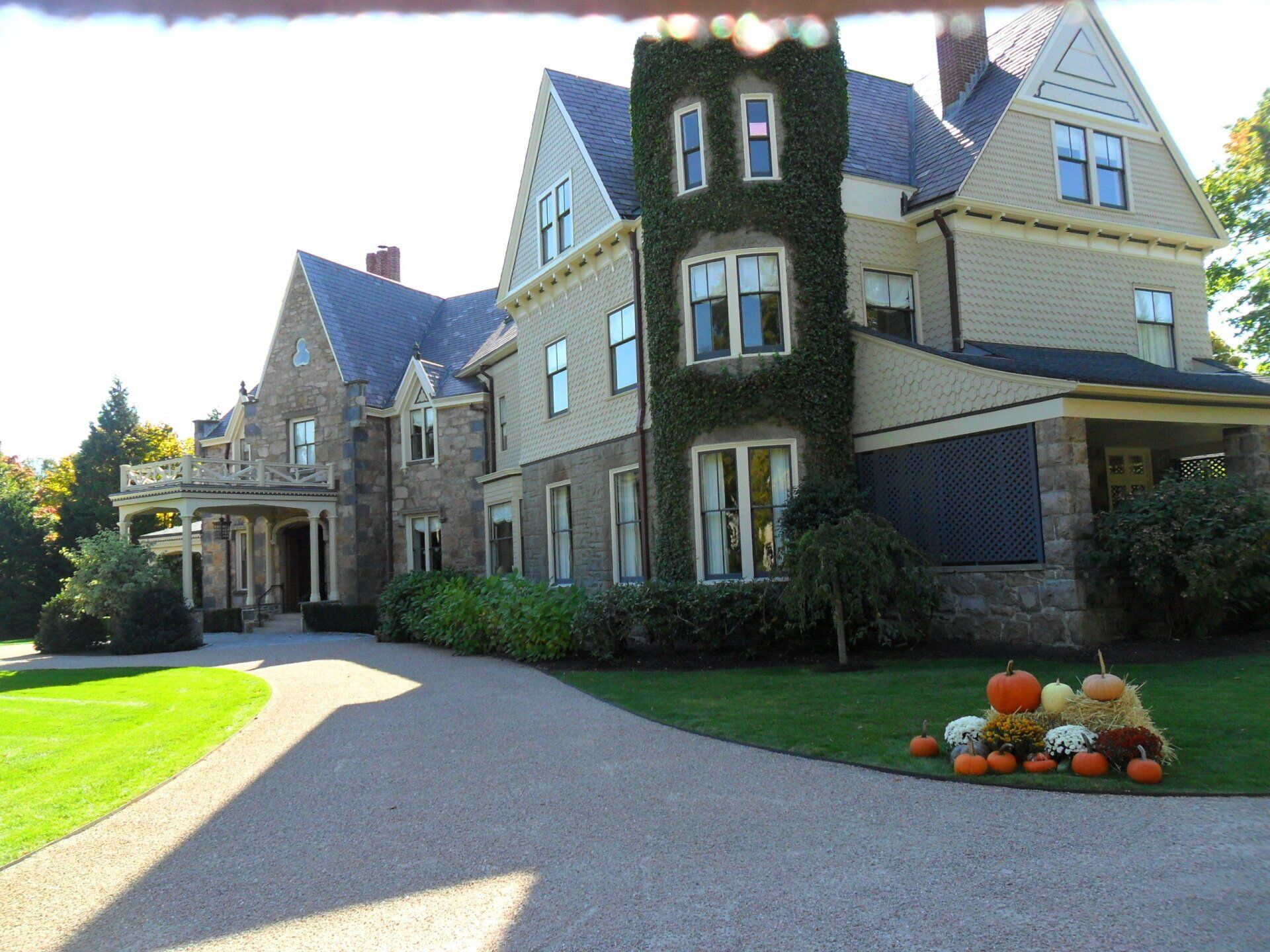 A large house with pumpkins in front of it