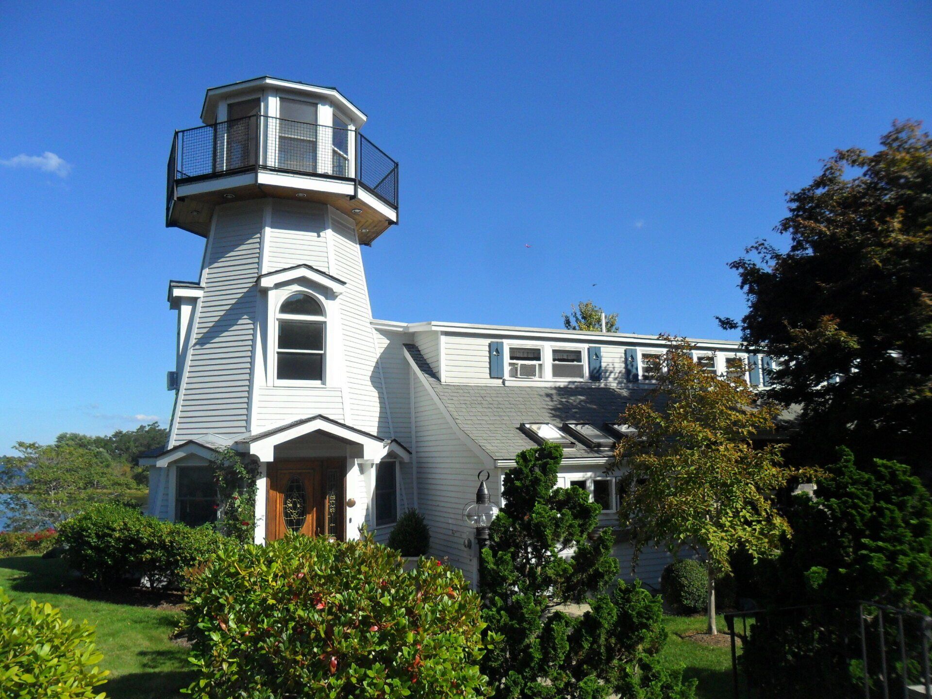 A white house with a lighthouse on top of it