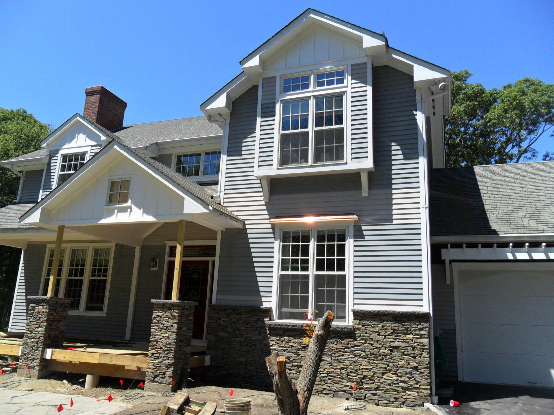 A house with a lot of windows and a garage