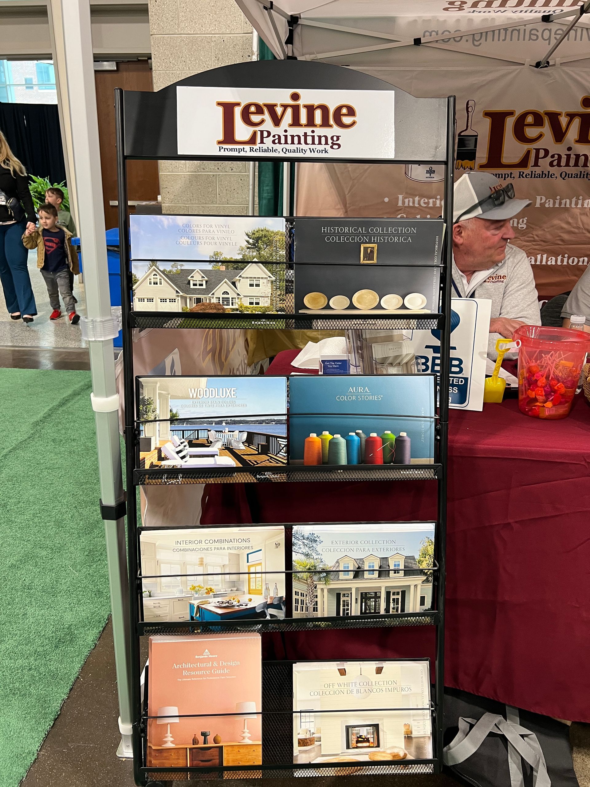 A display of levine painting books is sitting in front of a table.
