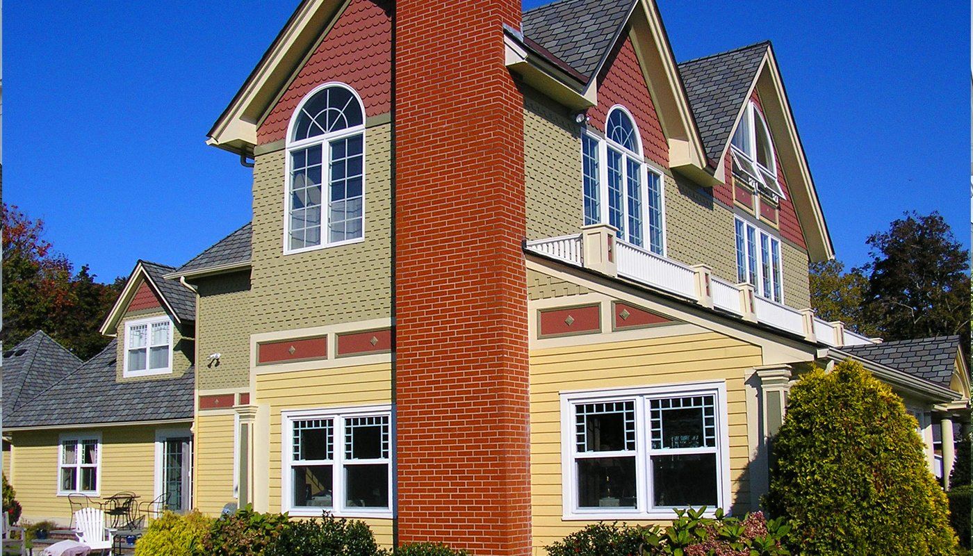 A large house with a brick chimney on the side