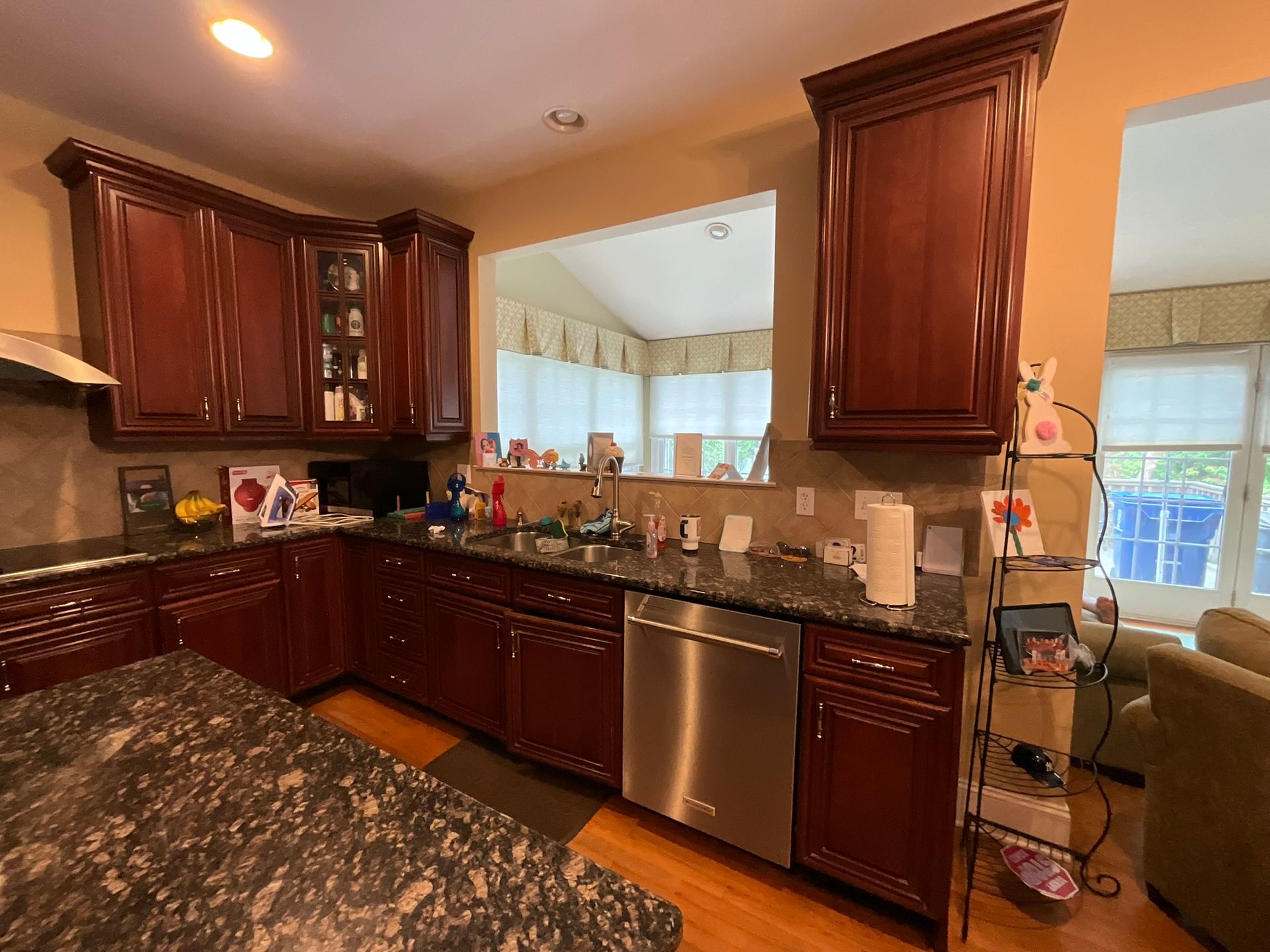 Kitchen with dark wood cabinets, granite countertops, and stainless steel appliances.