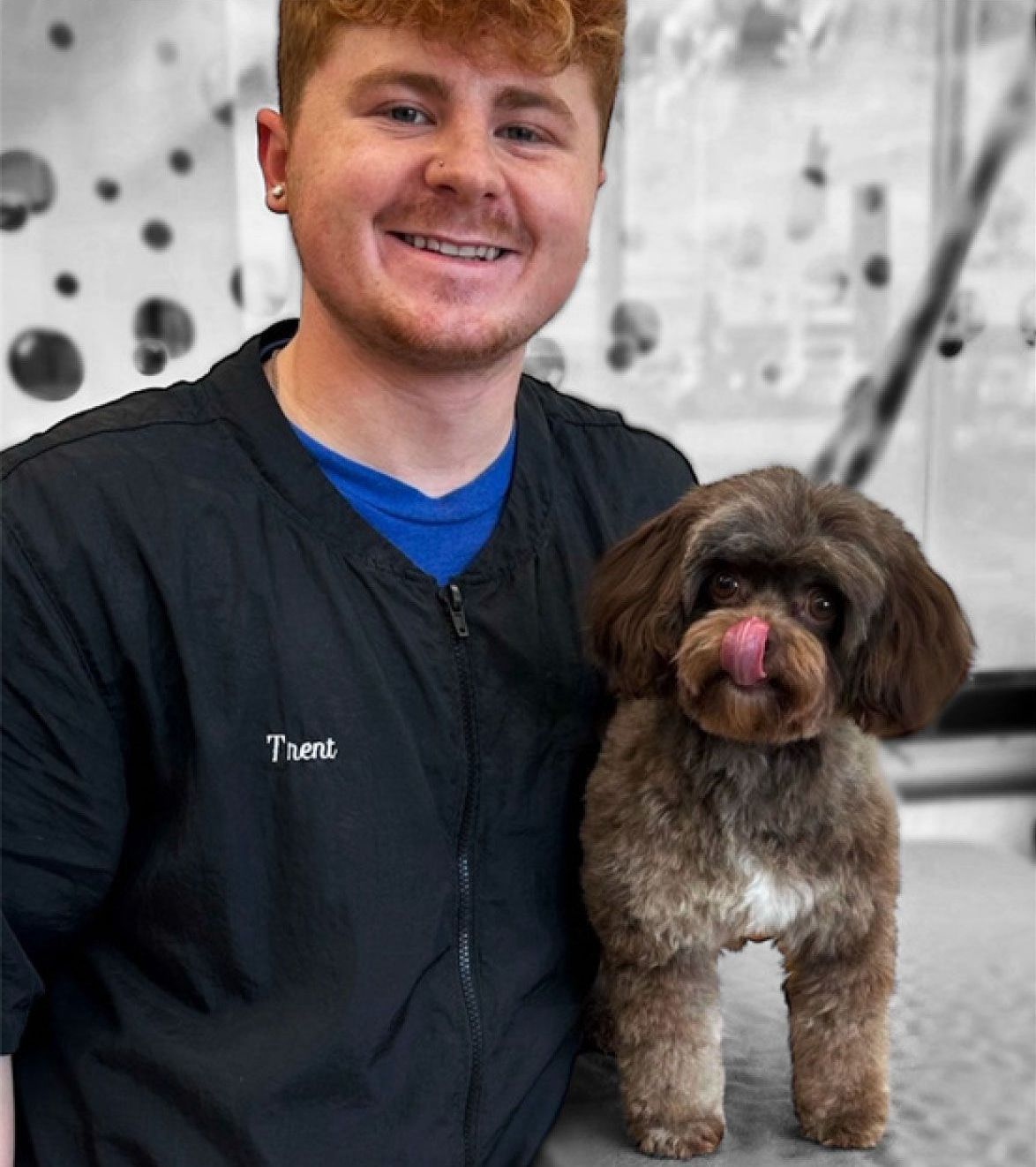 Trent Williams with a small brown dog.