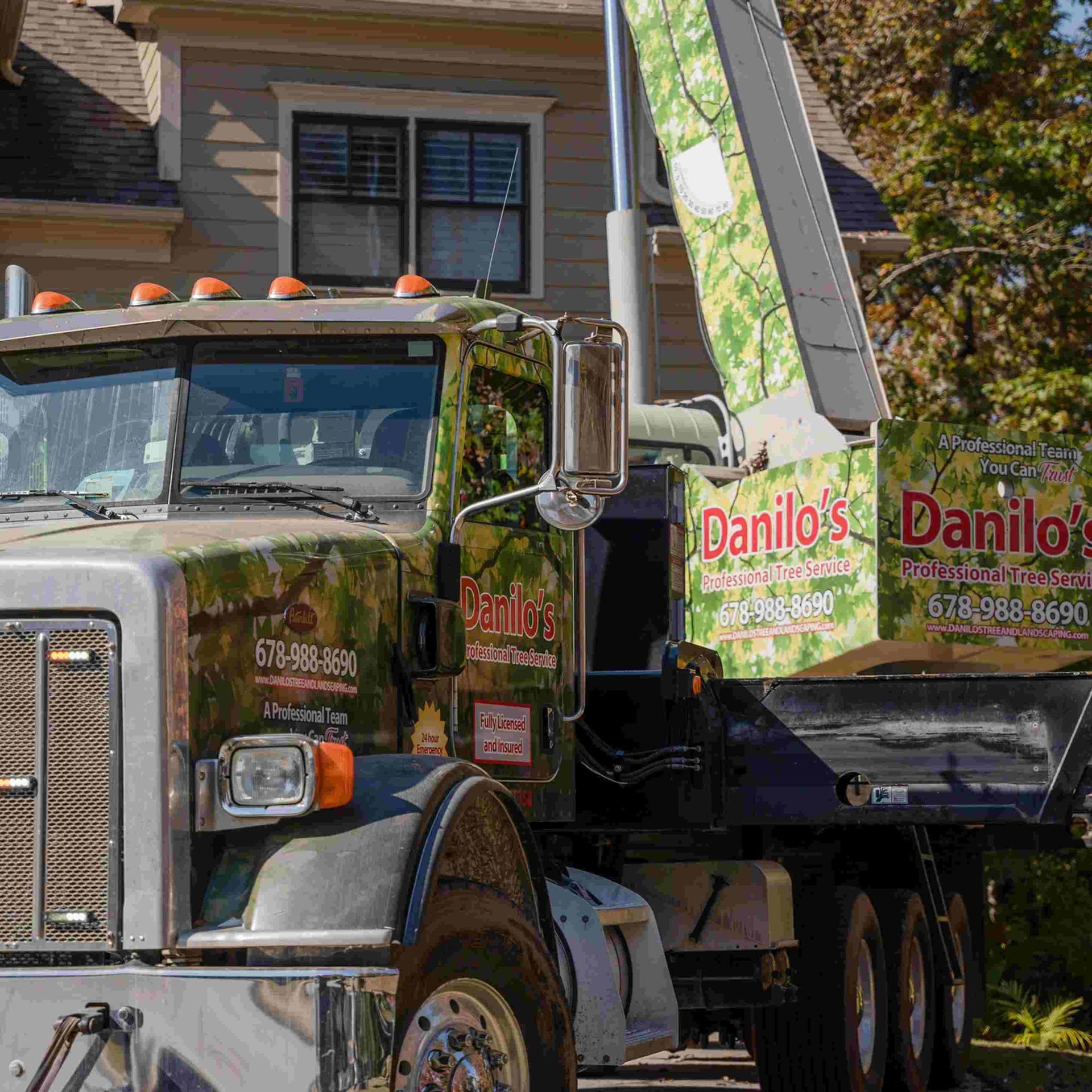 A danilo 's dump truck is parked in front of a house