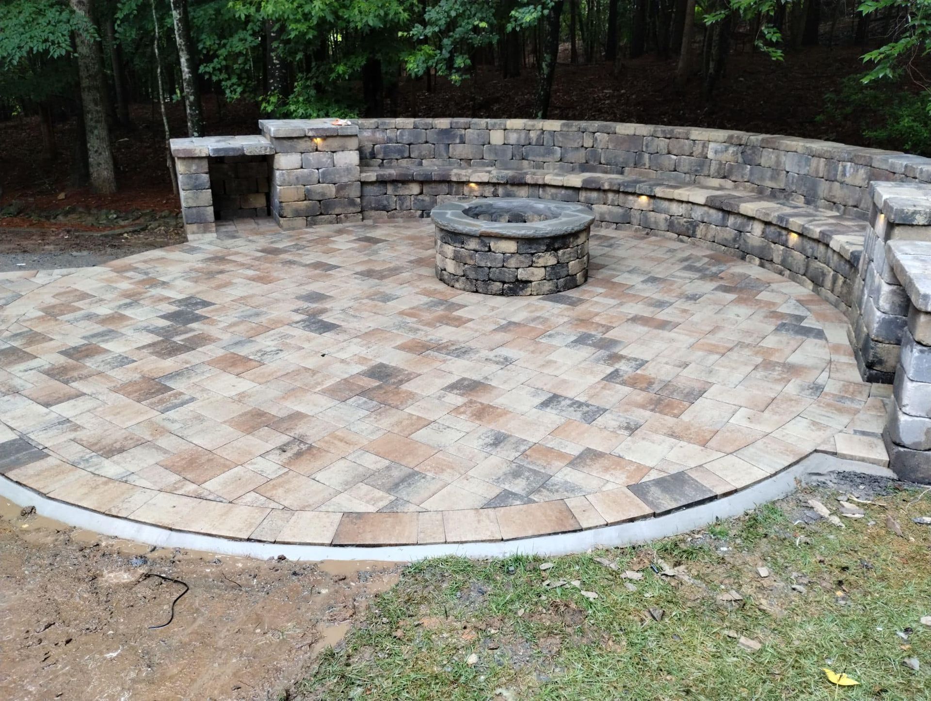 There is a fire pit in the middle of the patio.