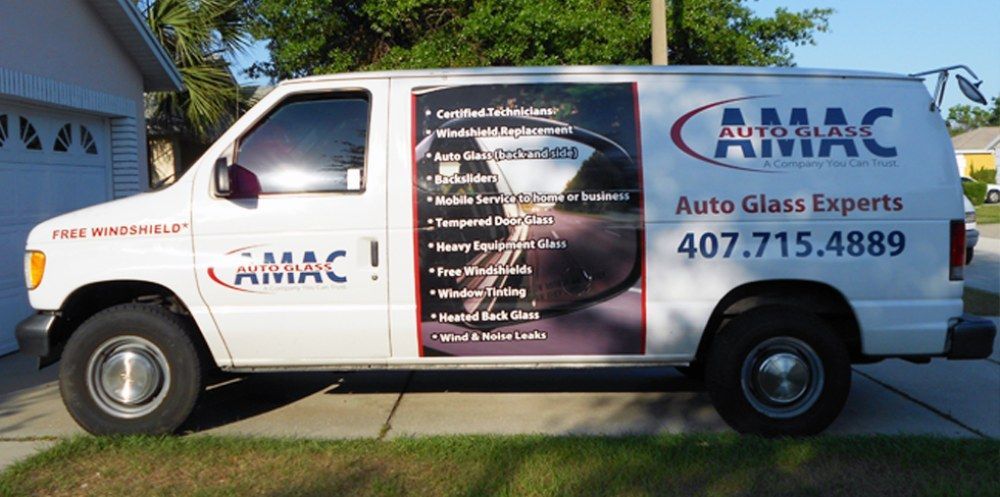 A white van that says camac auto glass experts