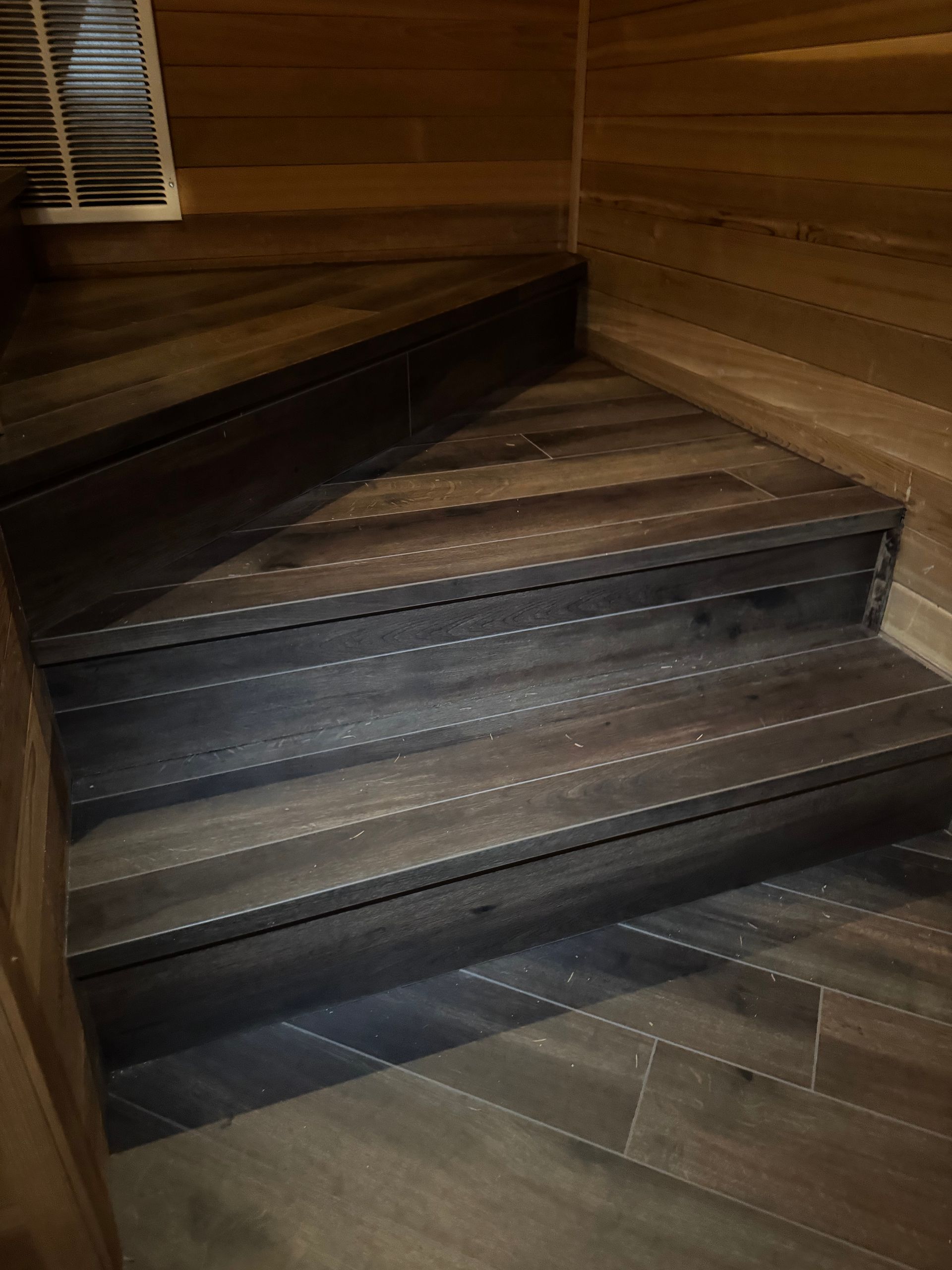 Wooden steps with a dark, textured finish.