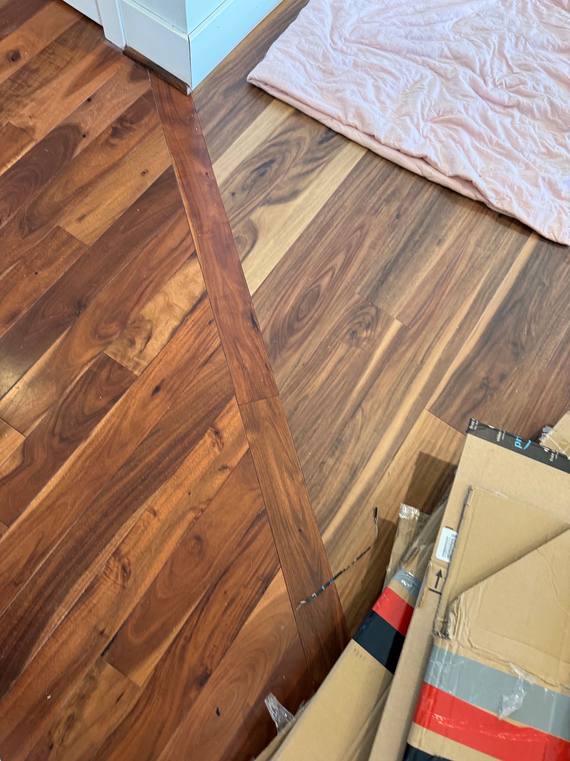Wooden floors and blanket with a saw cutting a line in the floor.