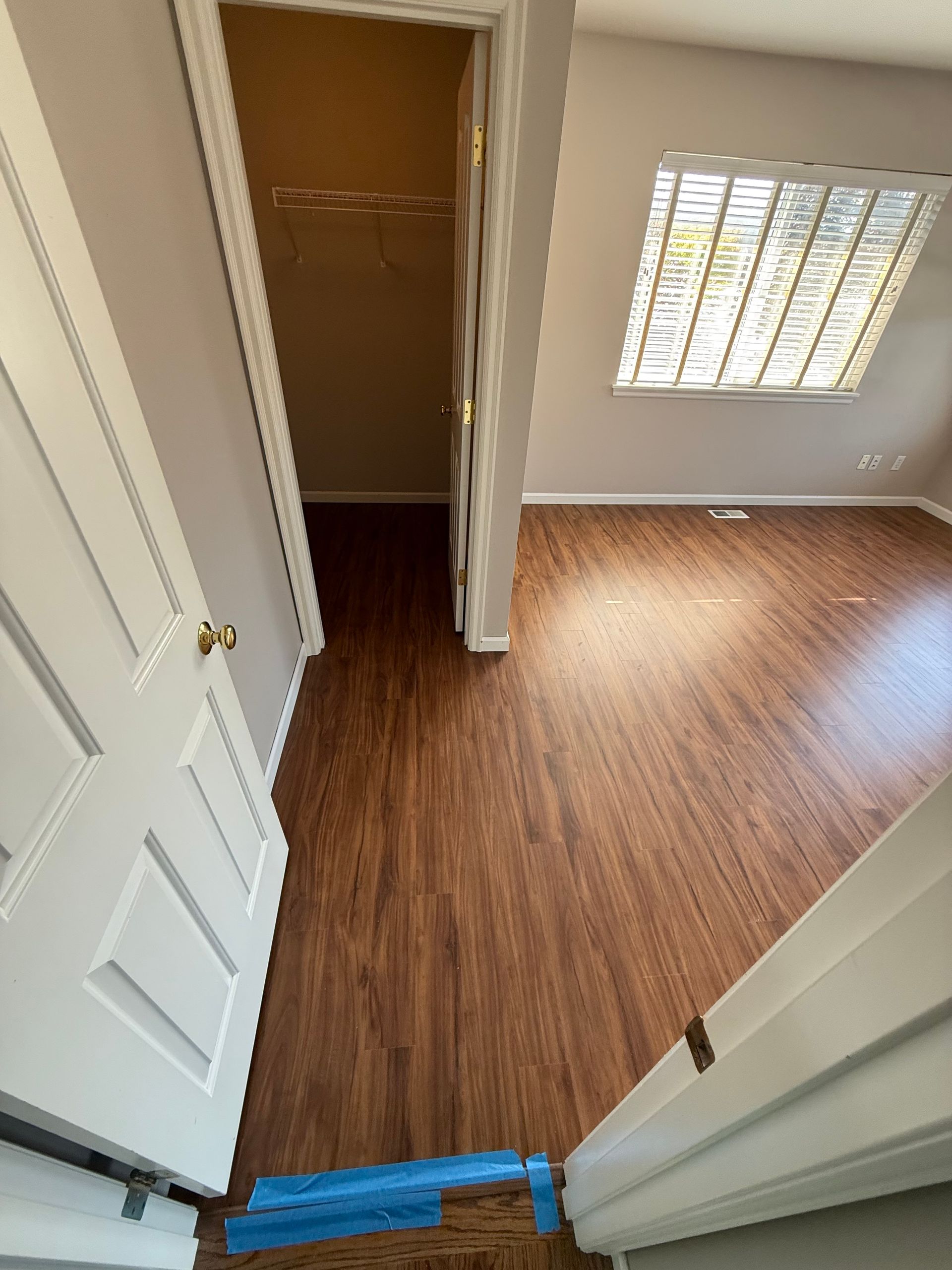 Open doorway to a bedroom with hardwood floors. A closet is visible on the left.