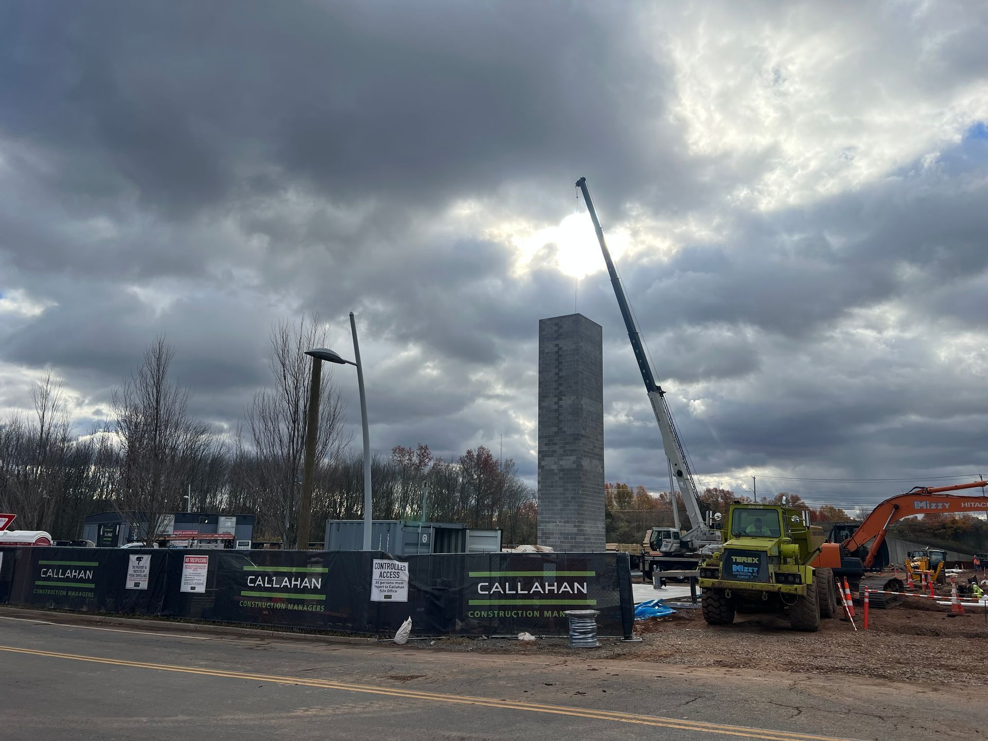 A crane near a tower on a work site