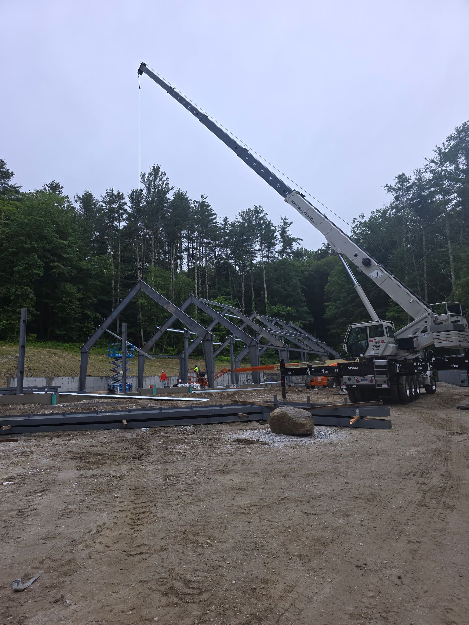 A white crane truck on a work site