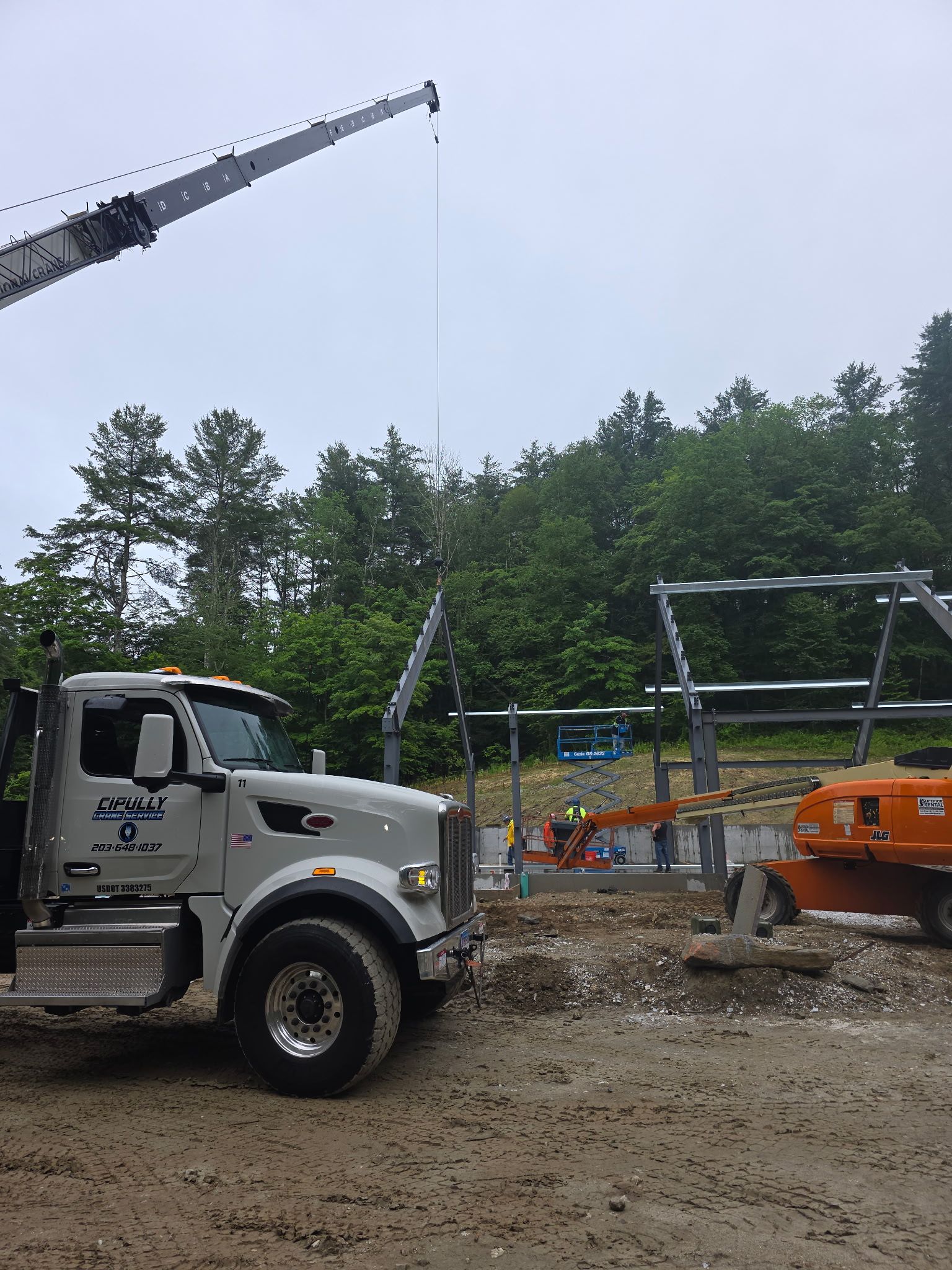 A white crane truck on a work site