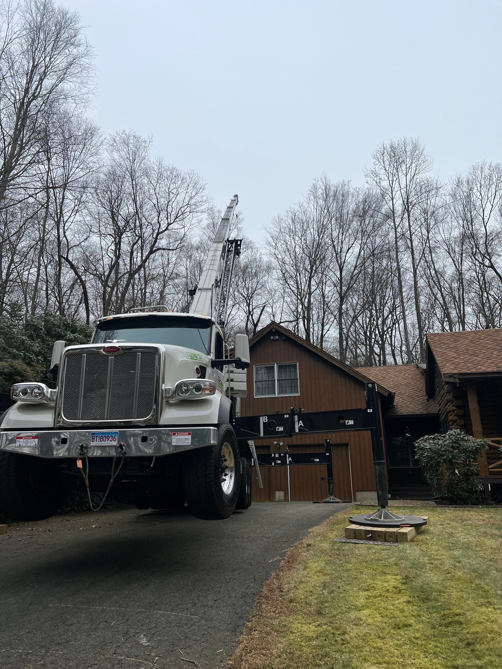 A large white truck is parked in front of a house.