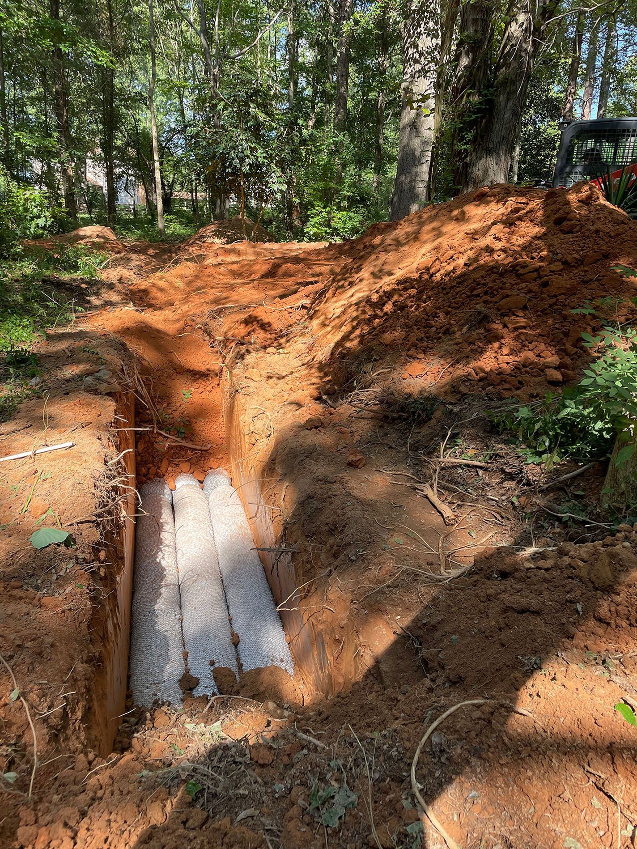 A large pile of dirt is sitting in the middle of a dirt field.
