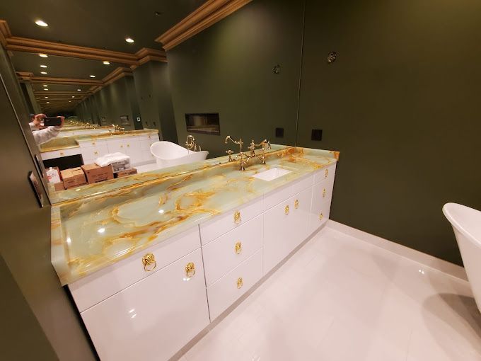 A bathroom with a large sink and a large mirror.