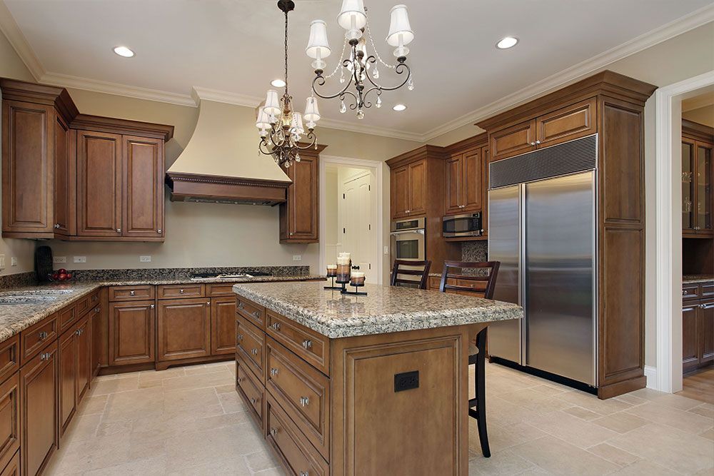 A kitchen with stainless steel appliances and wooden cabinets