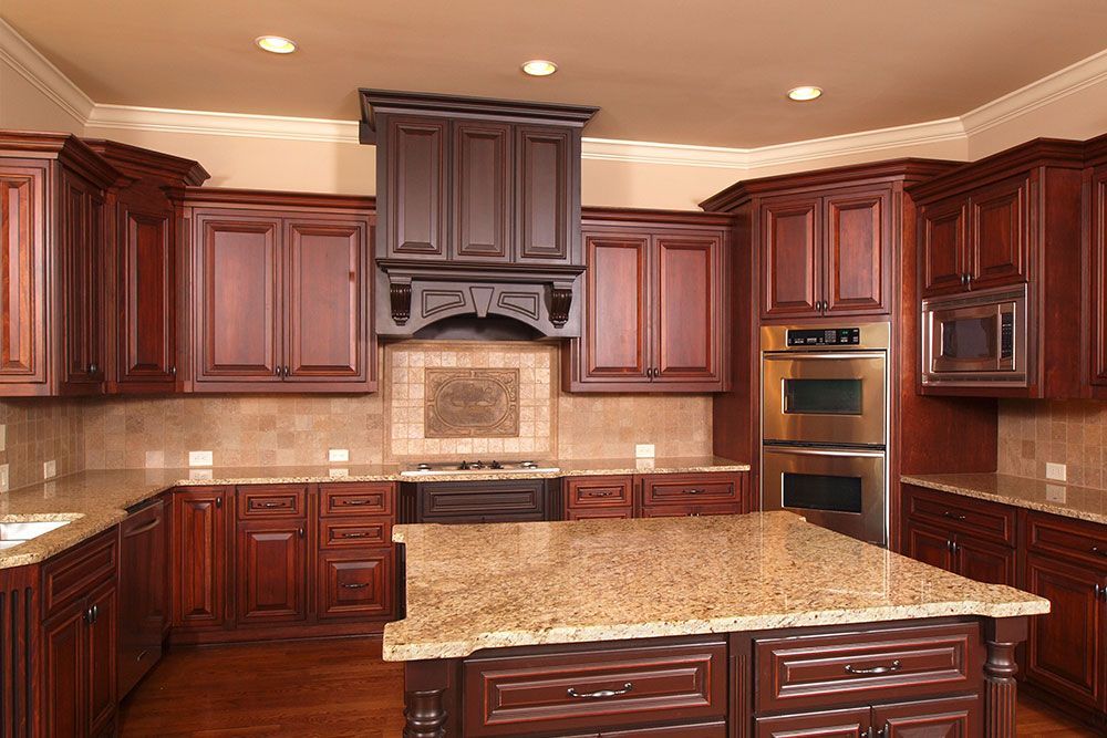 A kitchen with wooden cabinets and granite counter tops