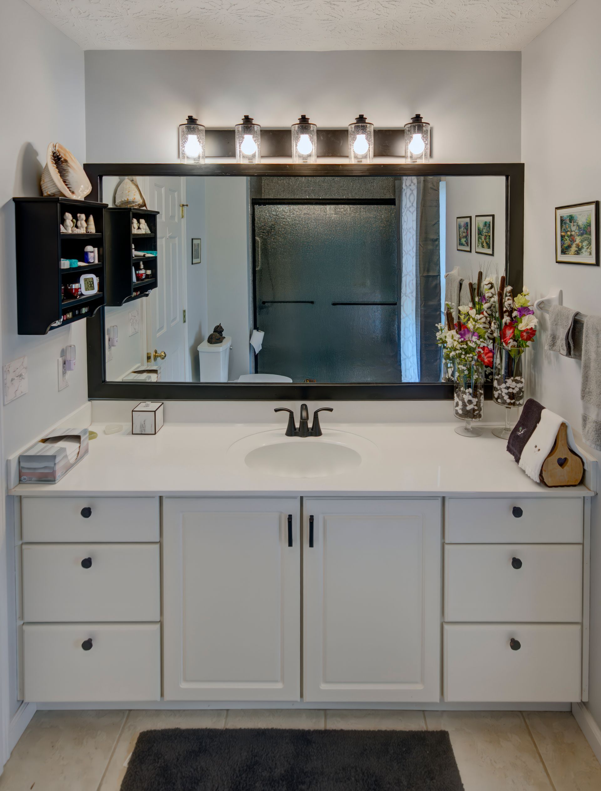 A bathroom with a sink and a large mirror