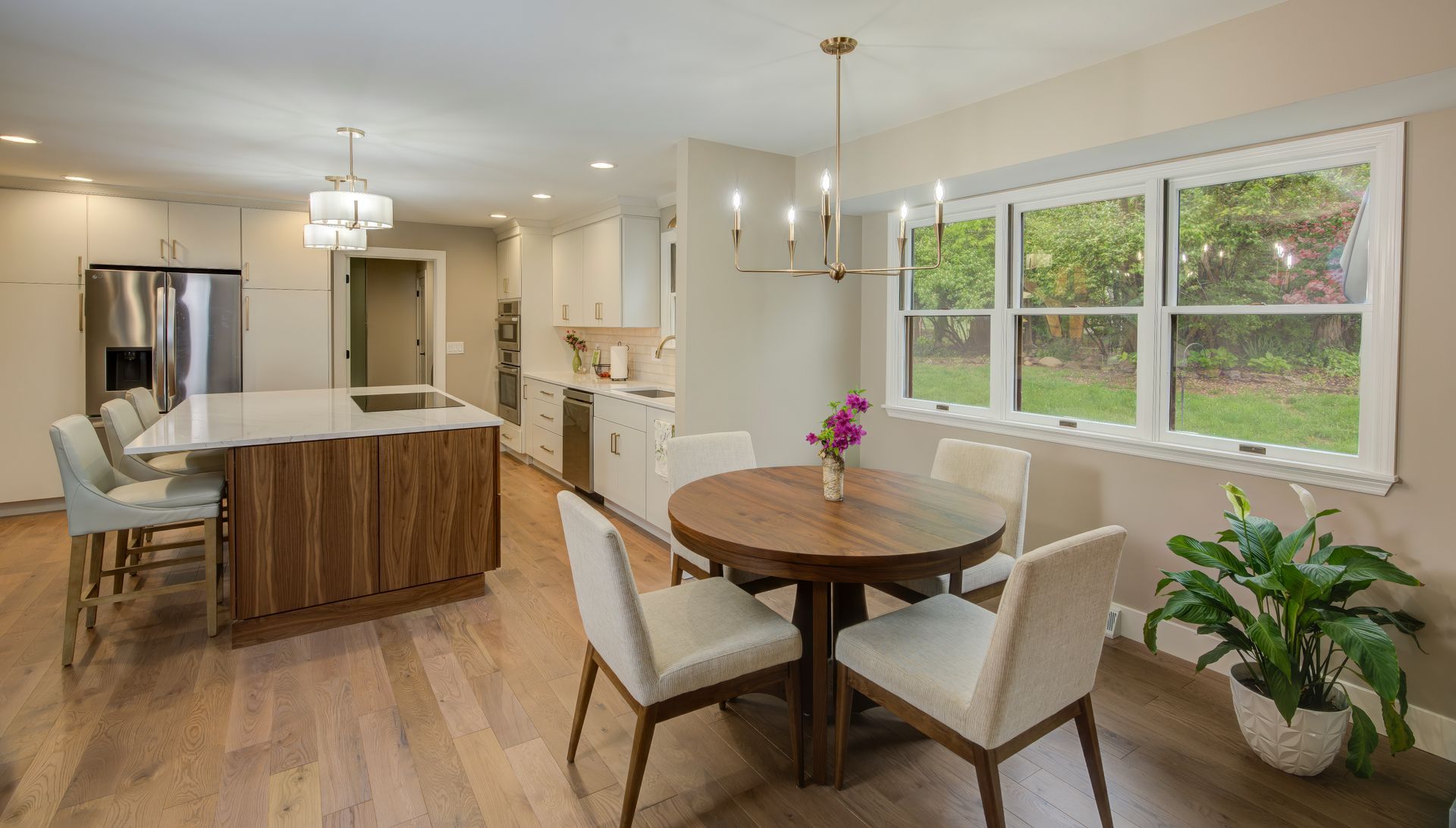A kitchen and dining room with a round table and chairs.