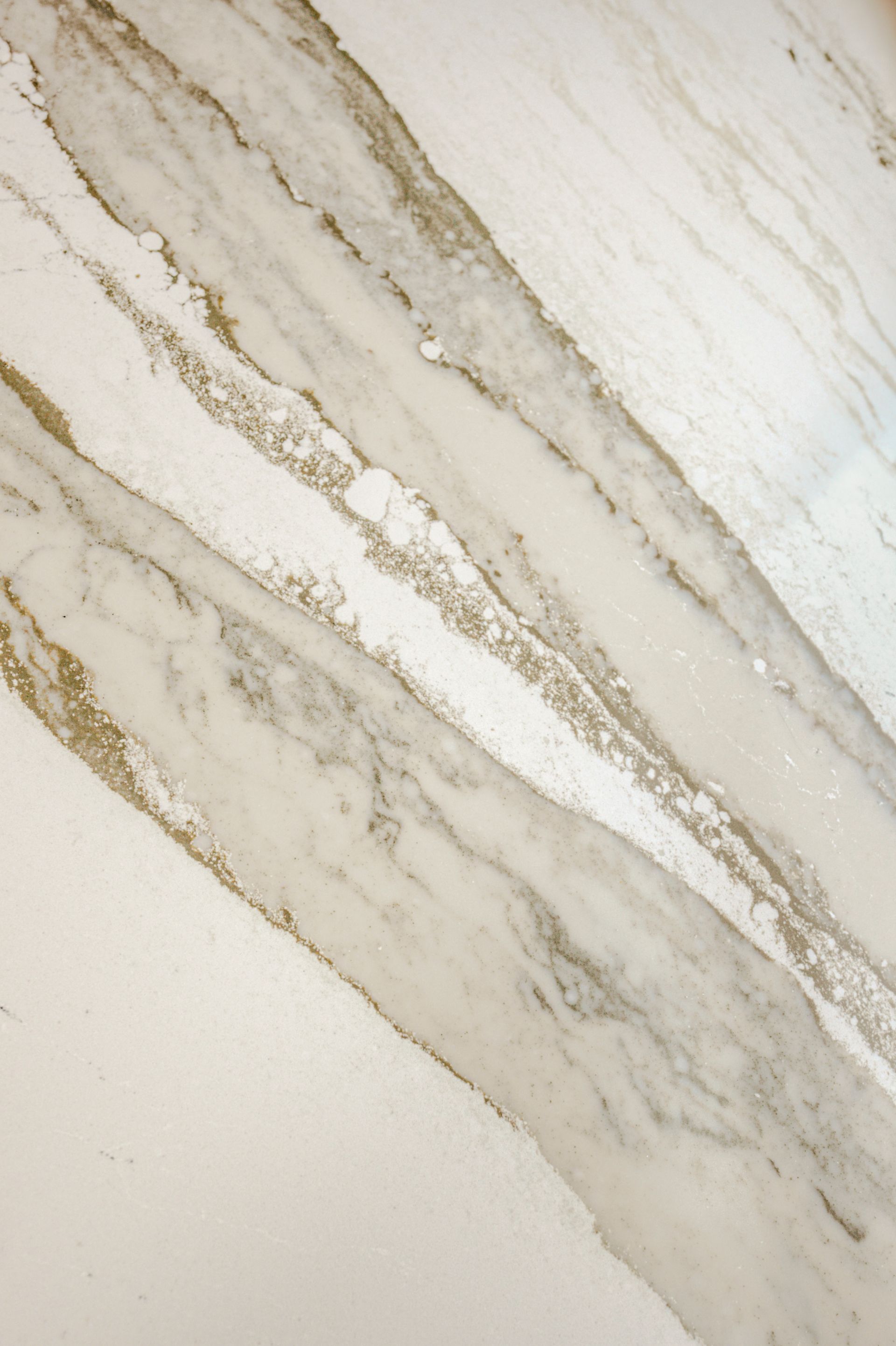 A close up of a white marble counter top.