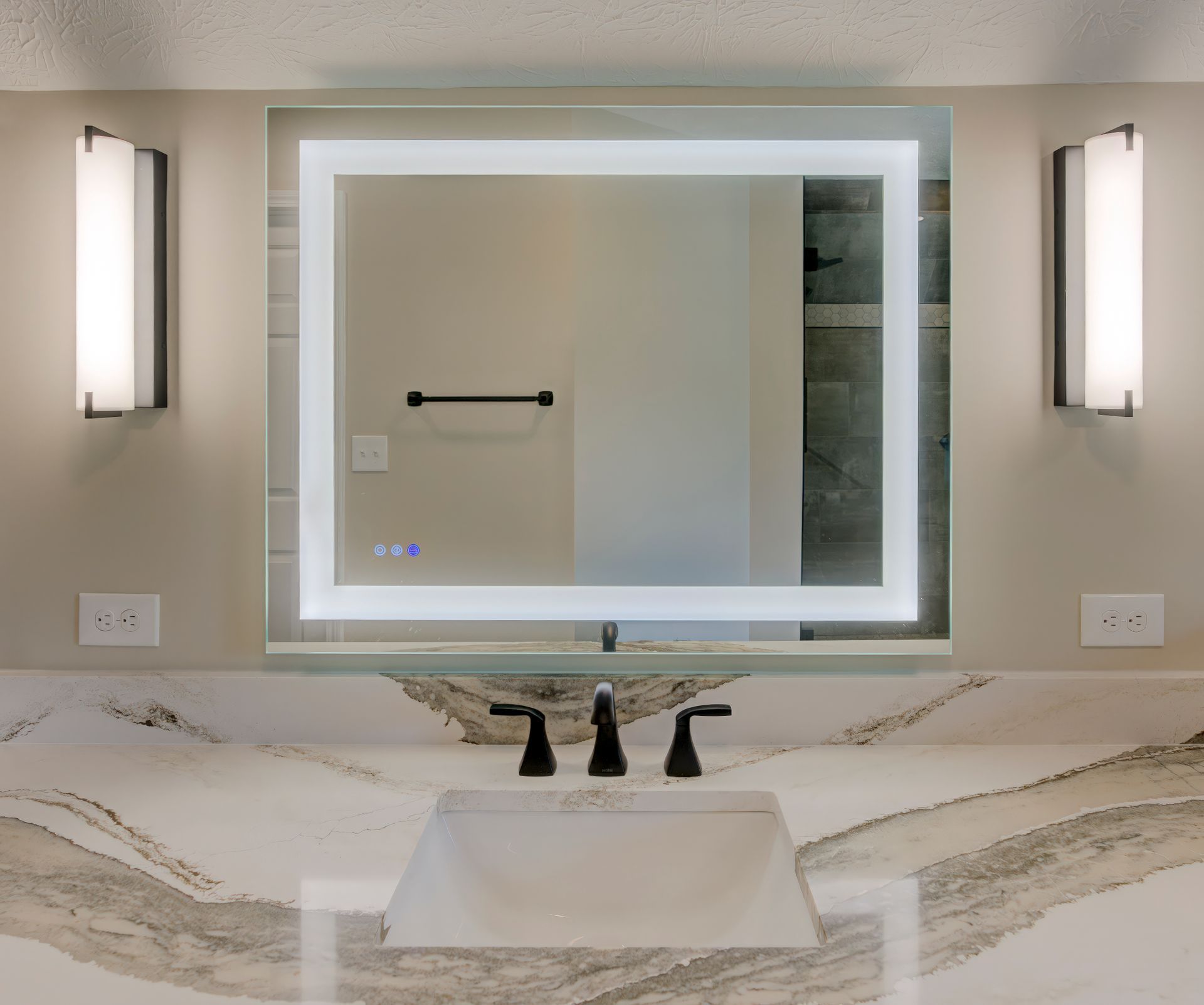 A bathroom with a large mirror and a sink